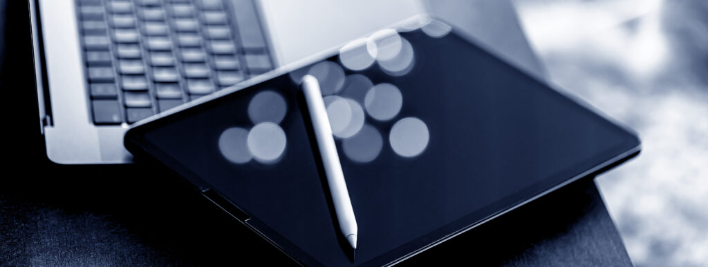 Business website design workspace with laptop and digital design tablet