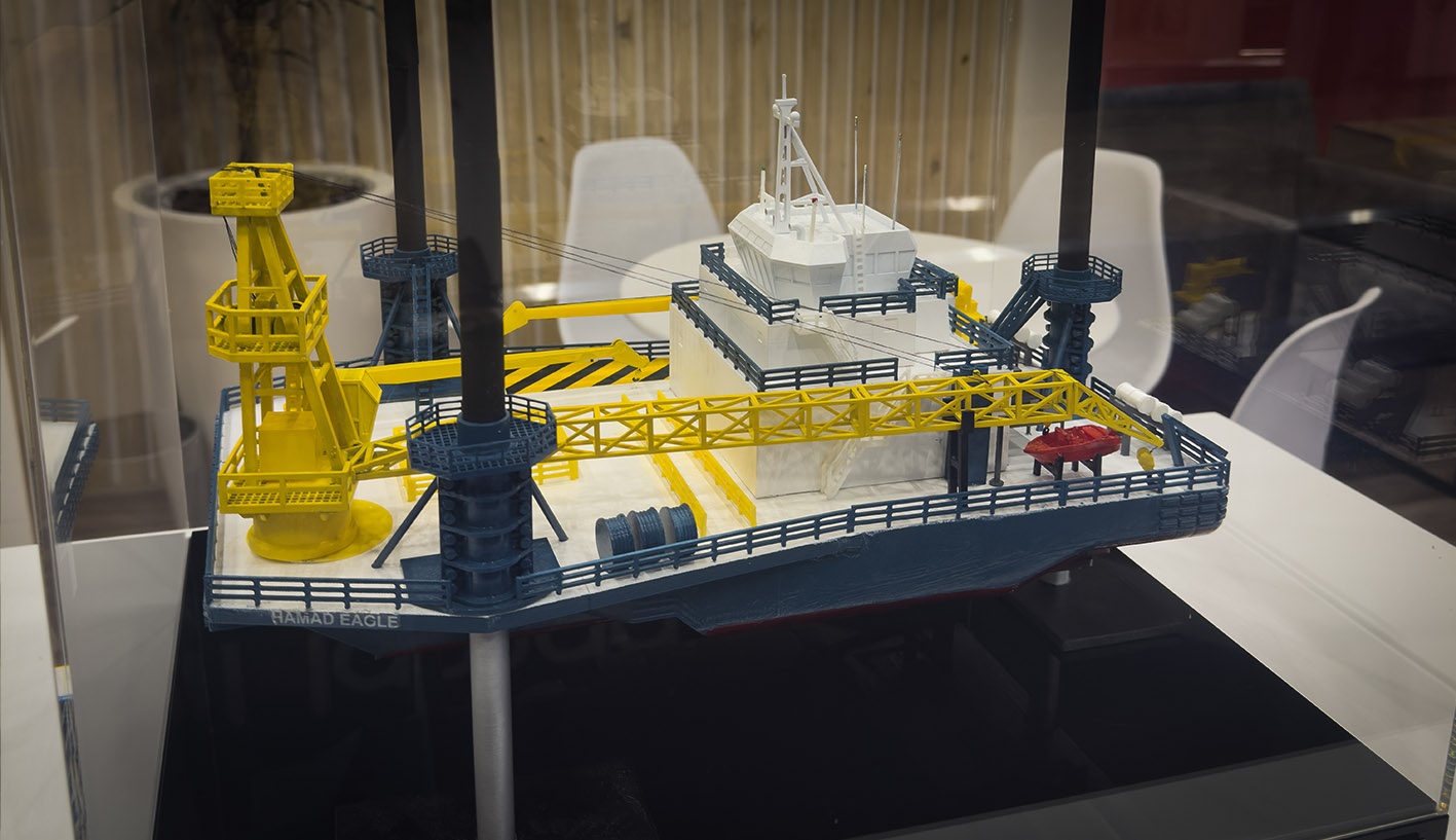 Detailed 3D scale model of the Hamad Eagle offshore liftboat displayed in a protective acrylic case at African Energy Week 2026.