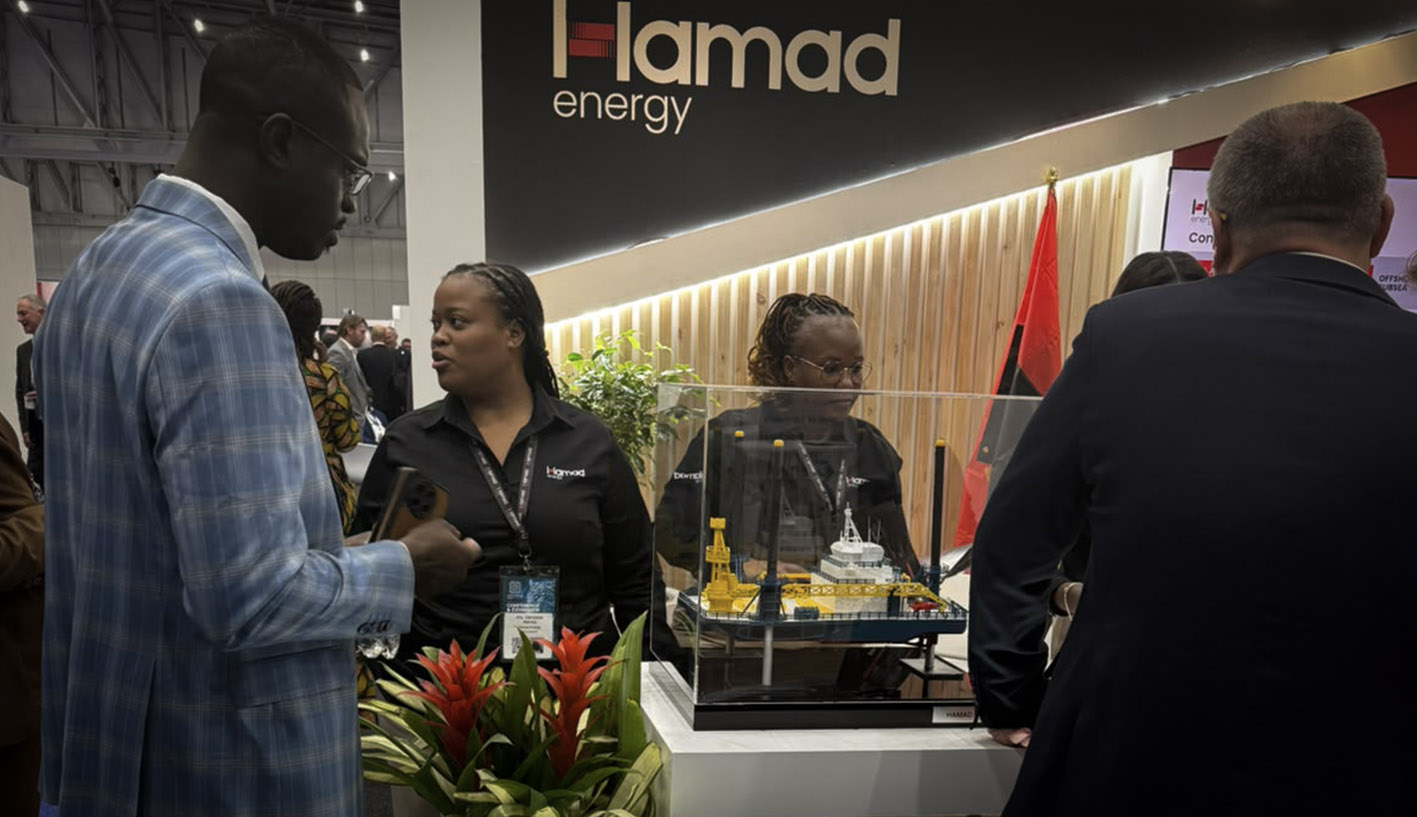Hamad Energy representatives engaging with exhibition visitors beside the Hamad Eagle model at African Energy Week 2026.